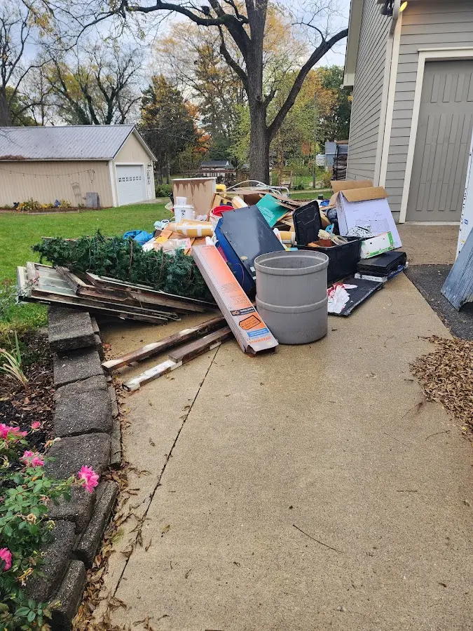 Dumpster being loaded with debris for 12 Yard Dumpster Rental in Charleston